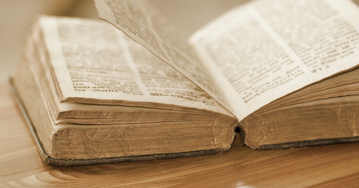 Vintage open book on a wooden table, highlighting old pages and text, perfect for knowledge and history themes.